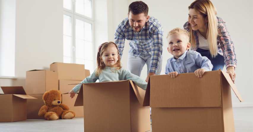 man and woman pushing boy and girl in boxes