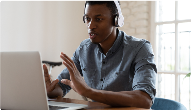 man chatting on call on laptop