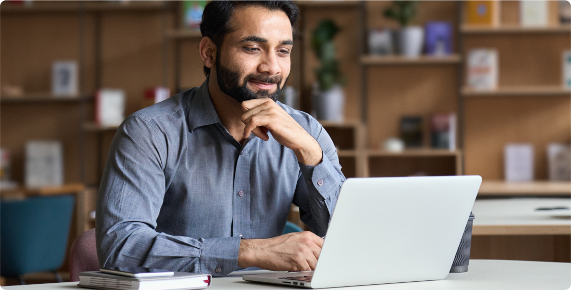 business man smiling at laptop
