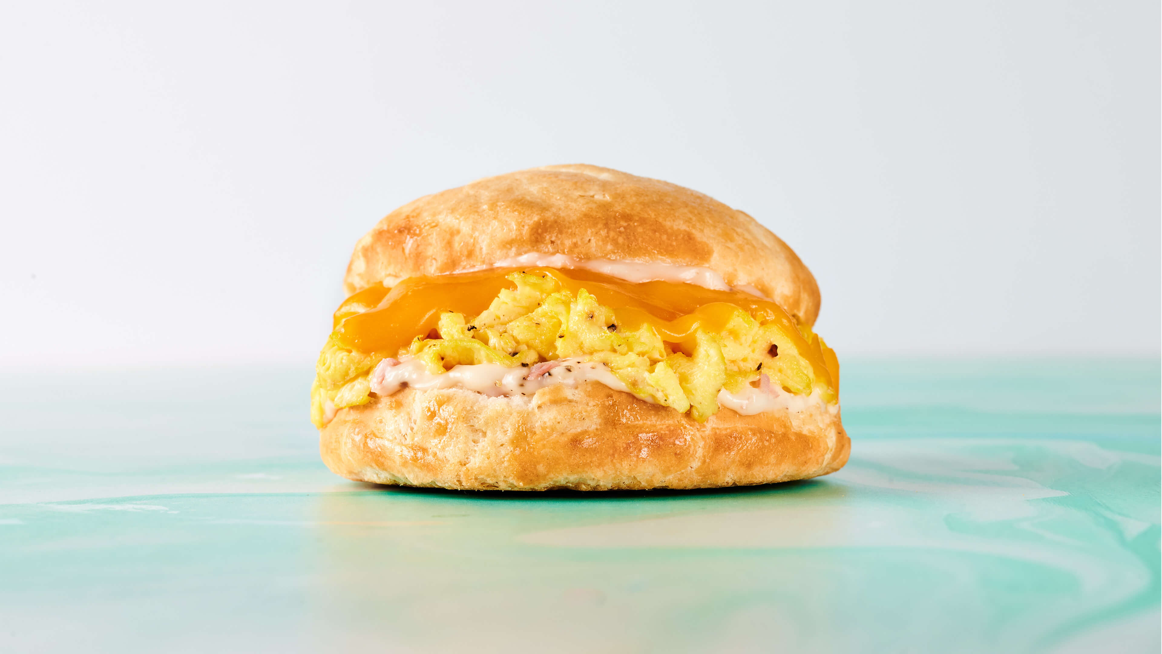 Yee Haw - Fluffy buttermilk biscuit stuffed with egg, cheddar cheese, and country ham aioli