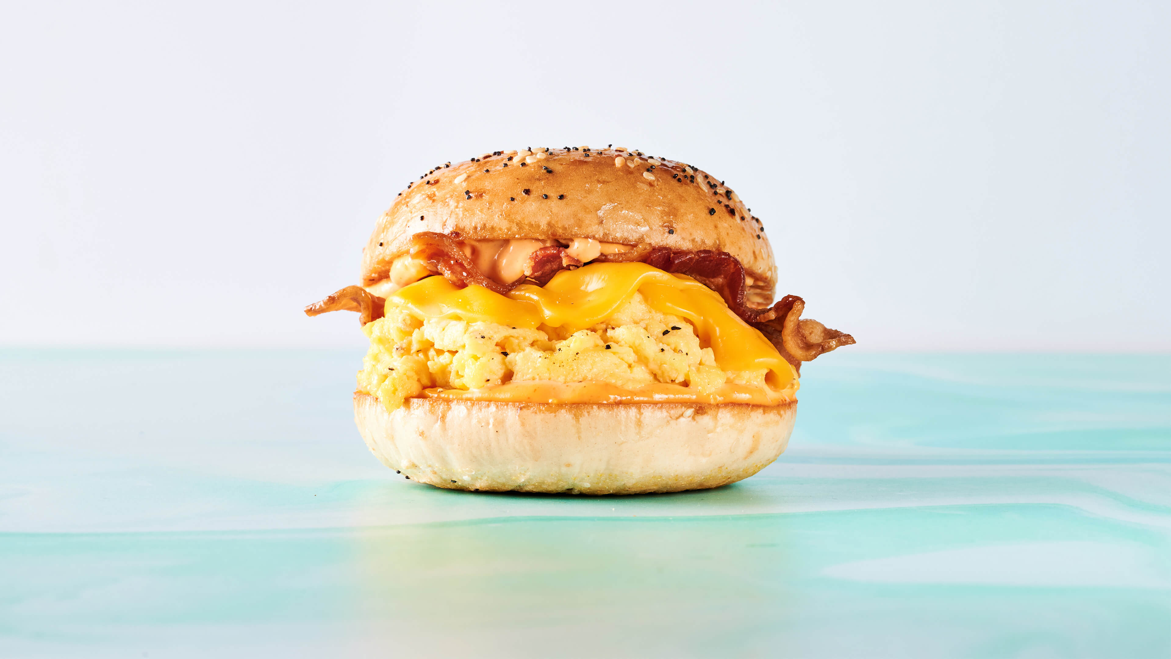 Basic B. - Bacon, egg, American cheese, and spicy aioli on a toasted everything bagel