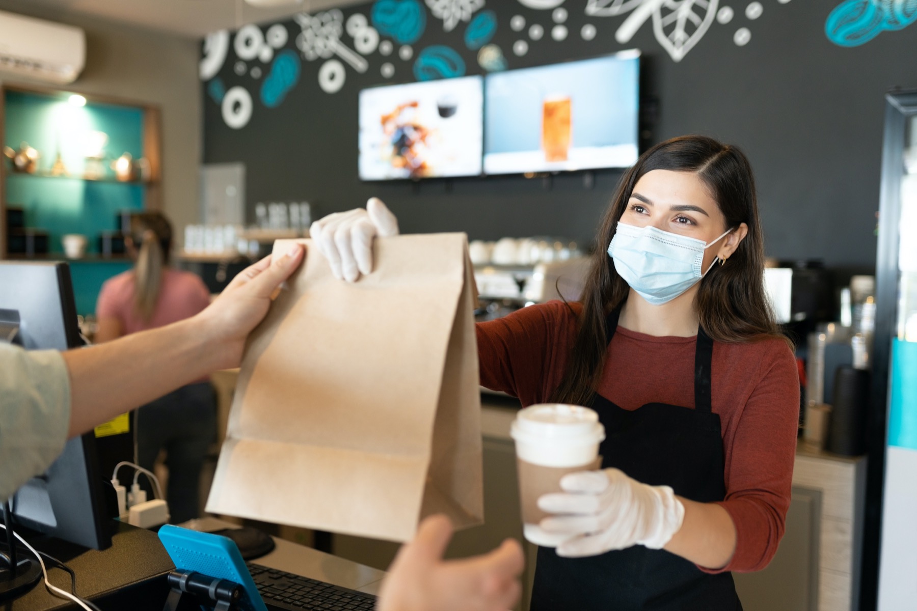 Restaurant worker handing food to customer