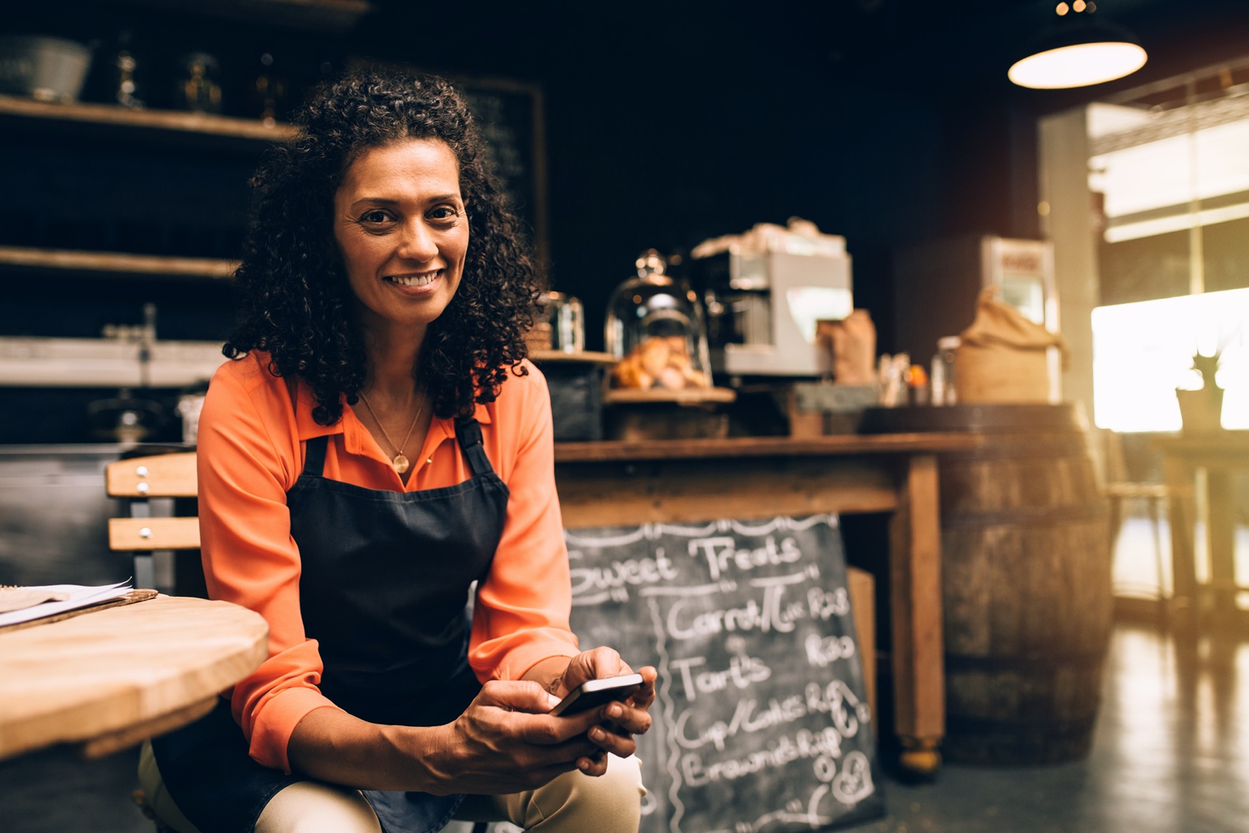 Restaurant employee doing workforce training on mobile phone