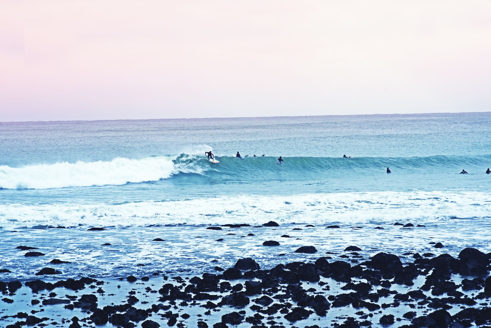 surfers riding a wave