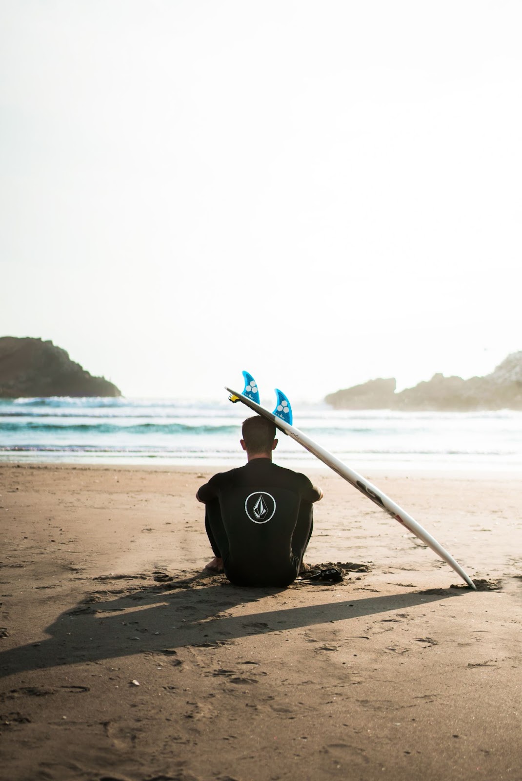surfboard leaning on a man's head