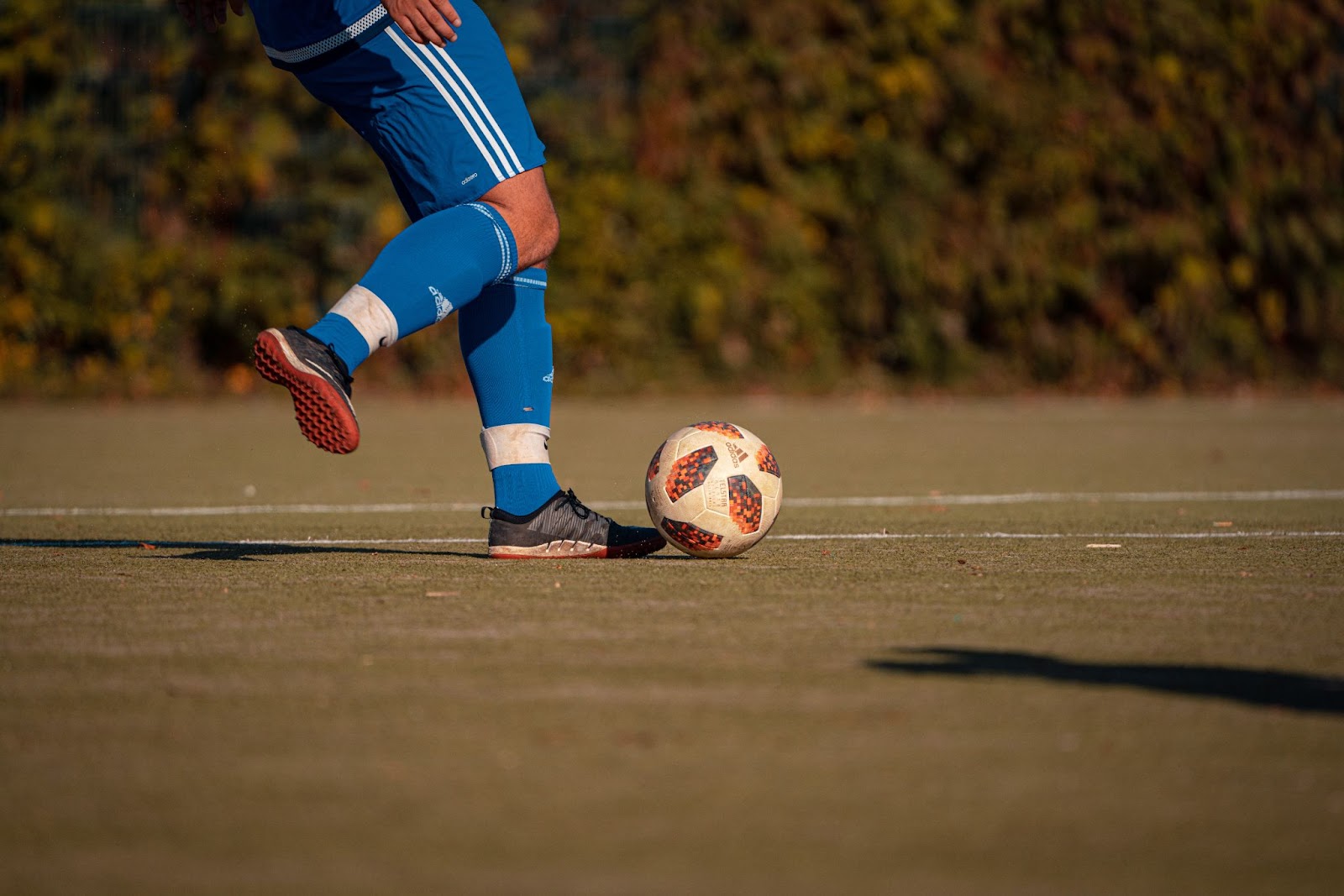 foot beside a soccer ball