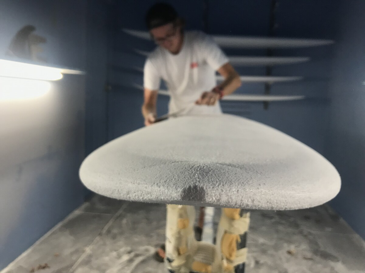 clayton nienaber shaping a surfboard