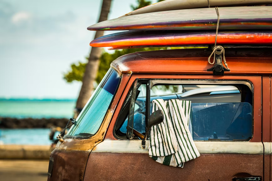 surfboards racked on a van