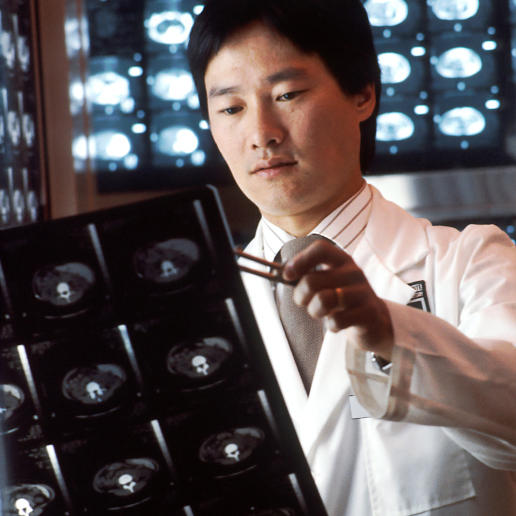 A scientist looking at brain scan.