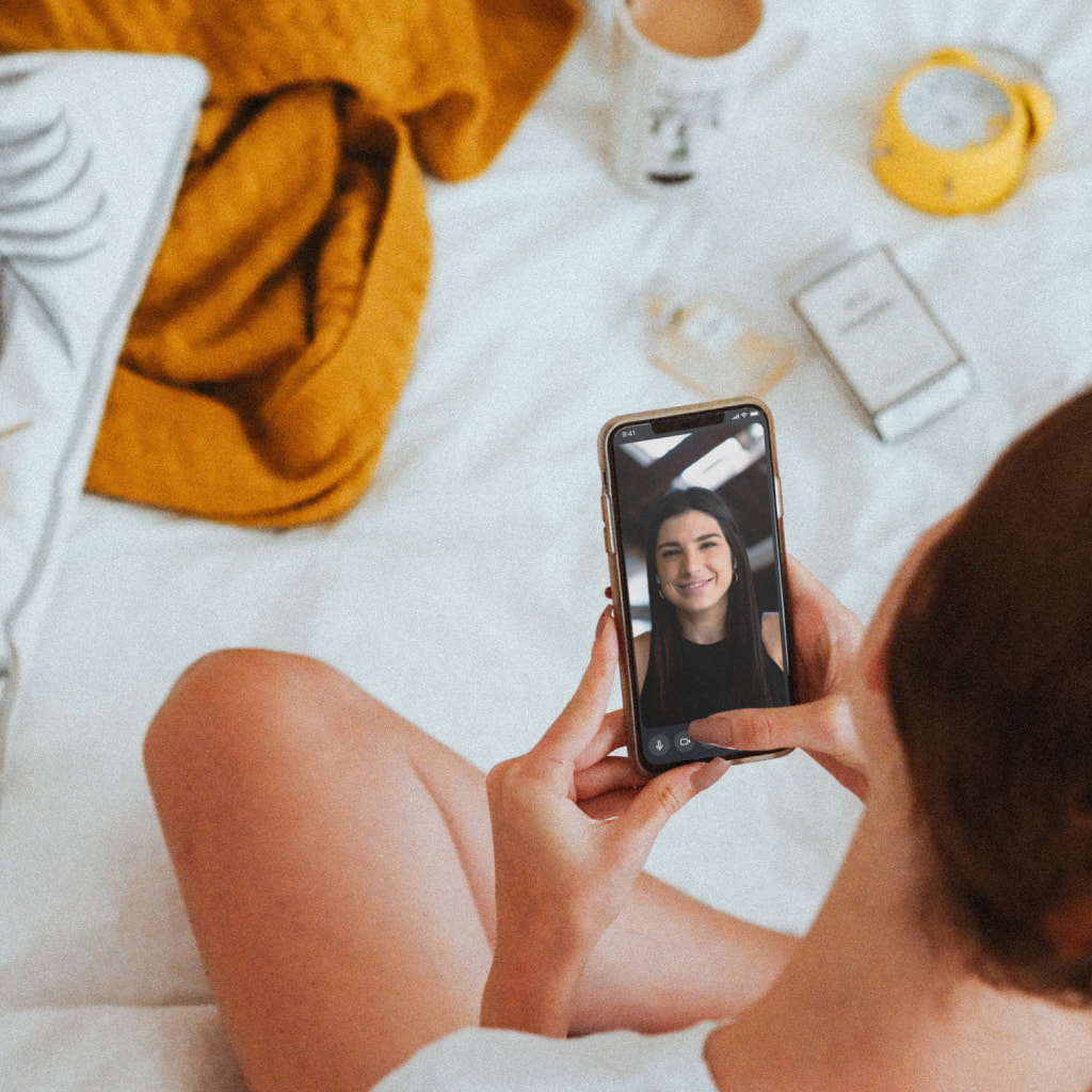 A woman having a video call with Aivo Coach