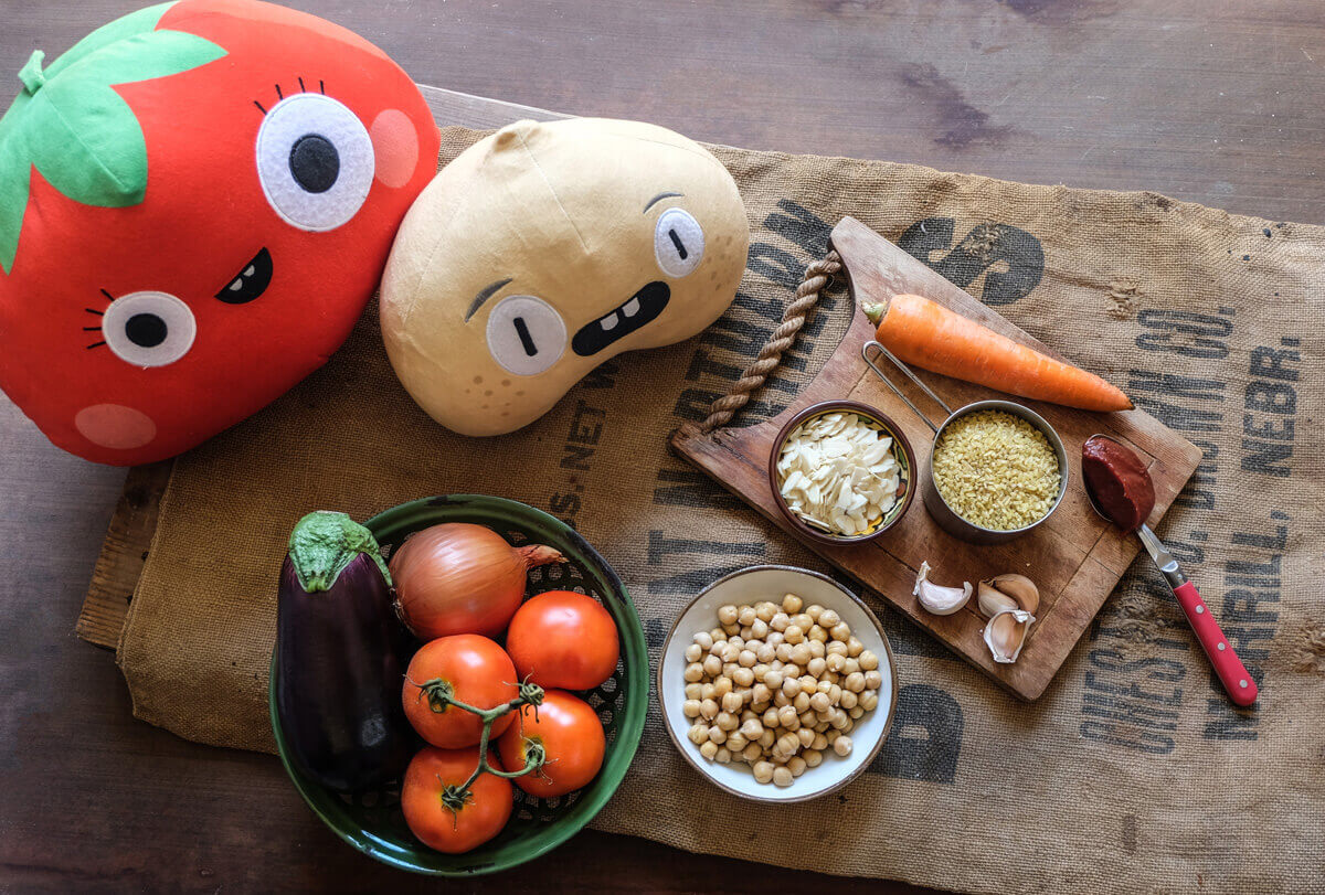 chickpea and tomato plushies helping to cook