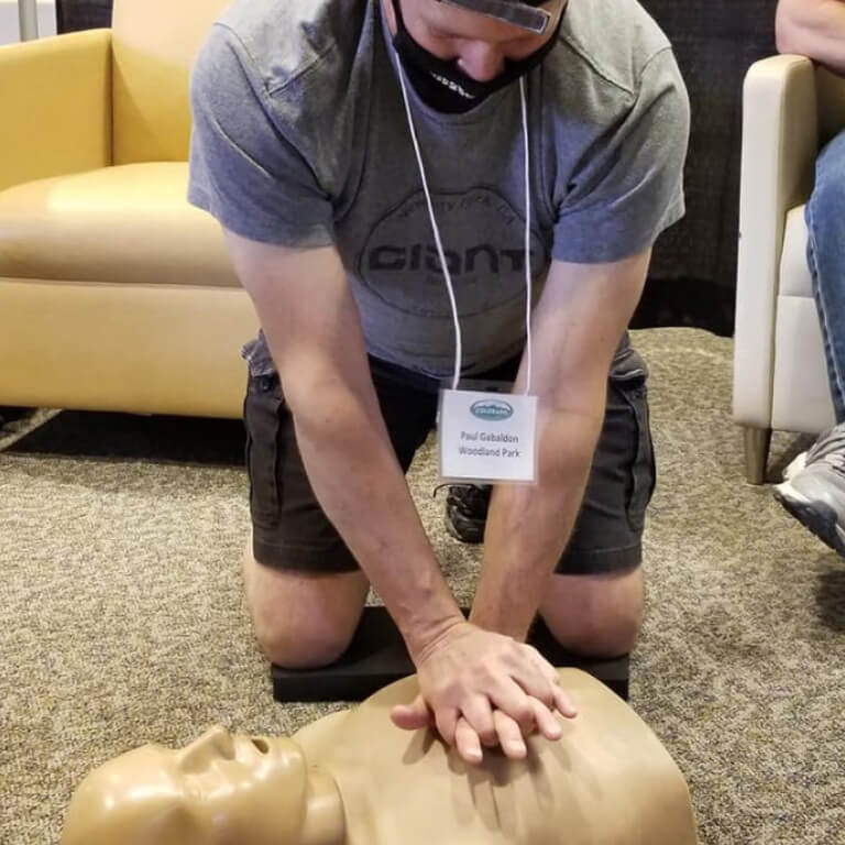 A student is performing the CPR technique on Silicon Body