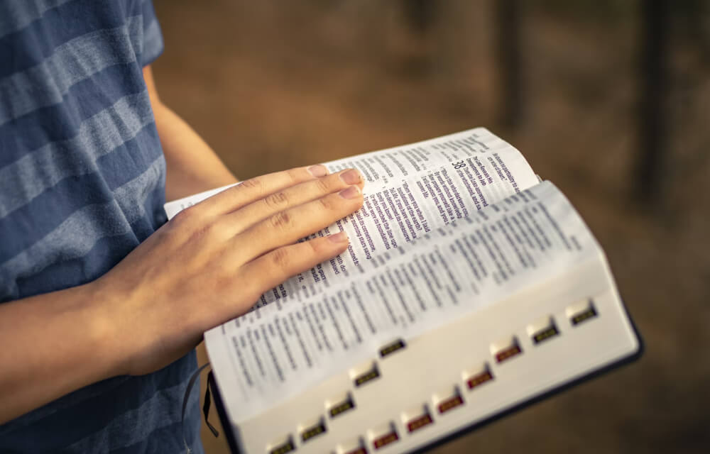 Open bible in hands