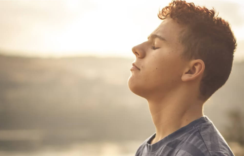 Young man with eyes closed and head up