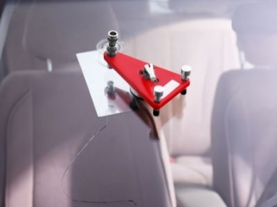 windshield chip repair tool affixed to a car windshield