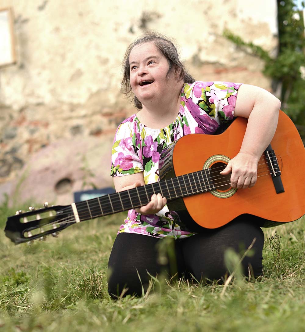 woman with autism playing guitar