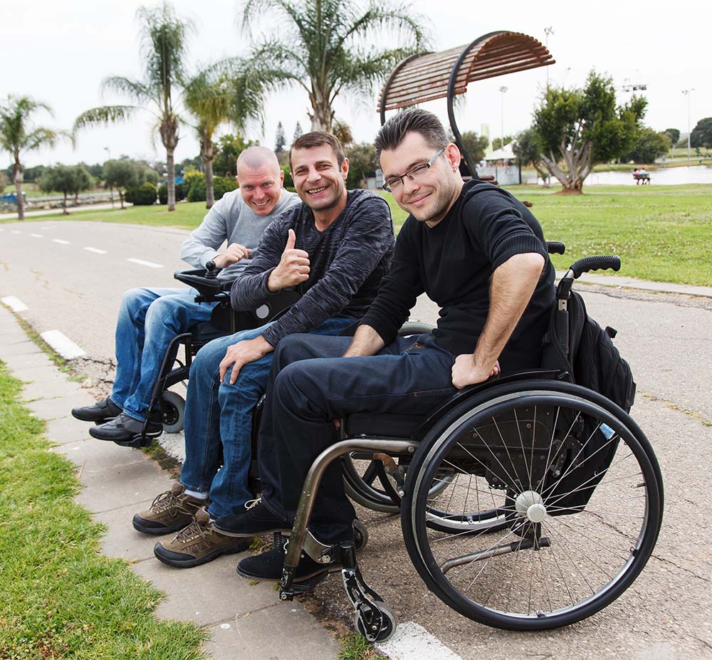 3 men on wheelchair