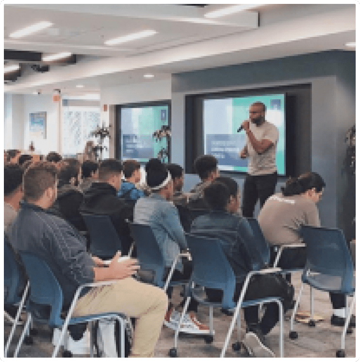 John D. Saunders giving a business presentation in a large group setting
