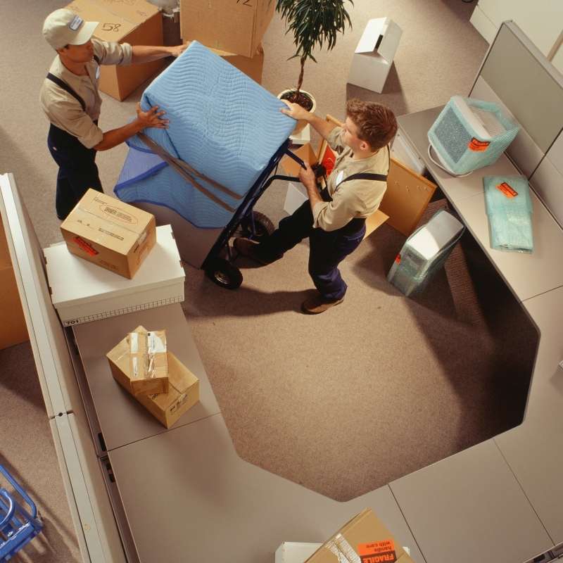 Commercial movers packing up the office desk