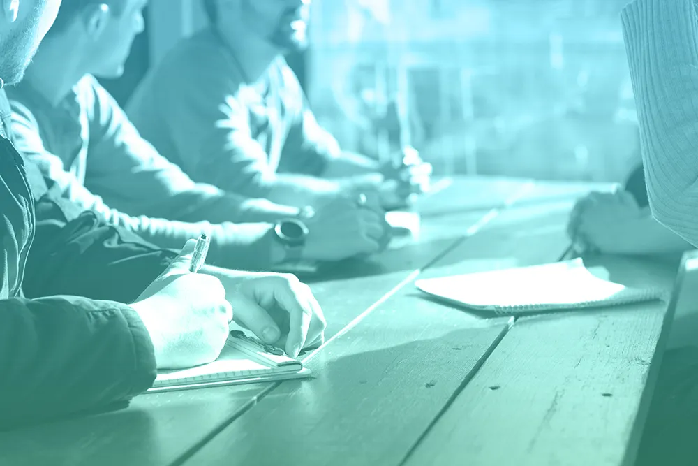 Men Taking Notes During A Meeting