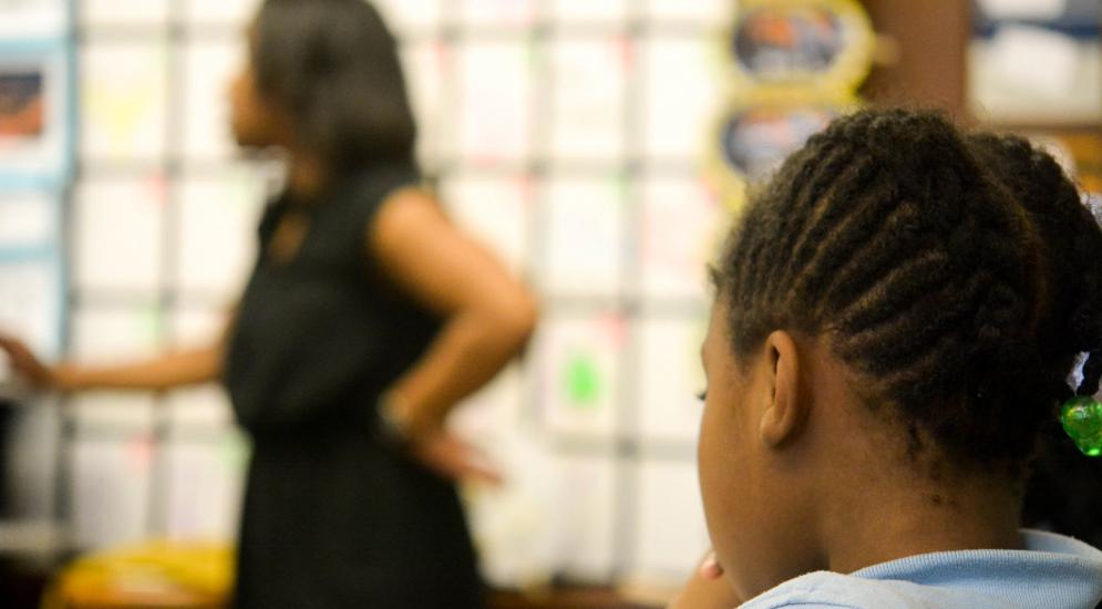 Student in classroom watching her teacher.