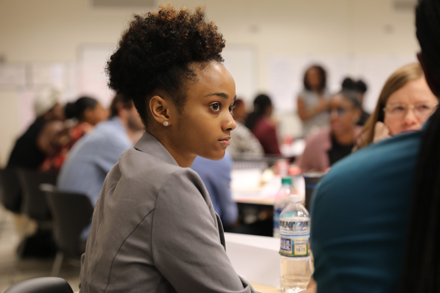 Relay student in a workshop, watching intently.