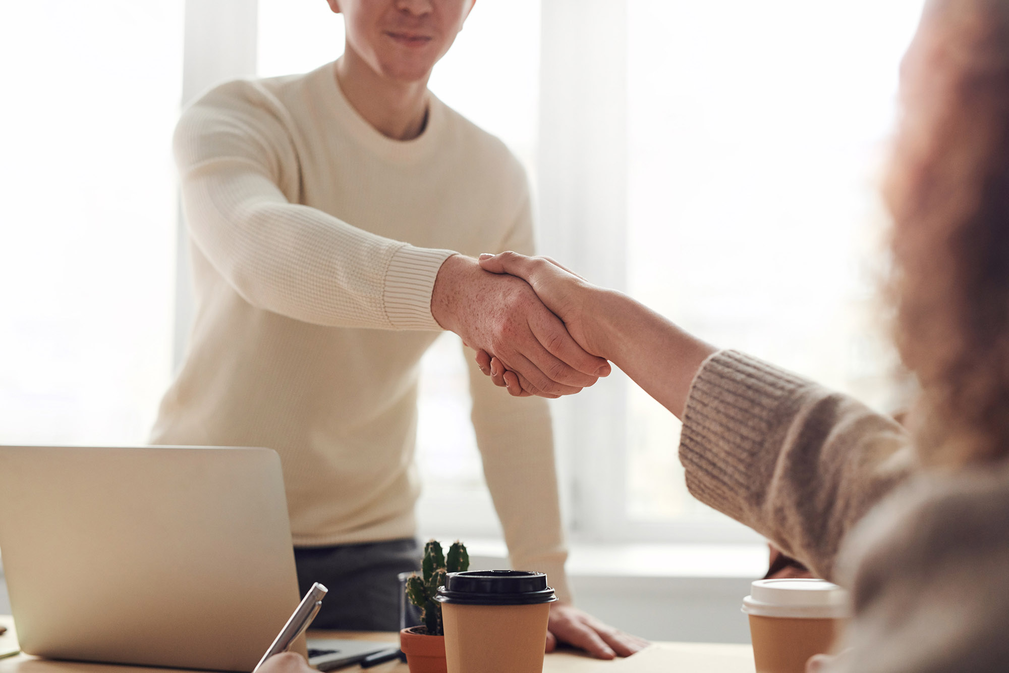 Man shaking hands in team meeting