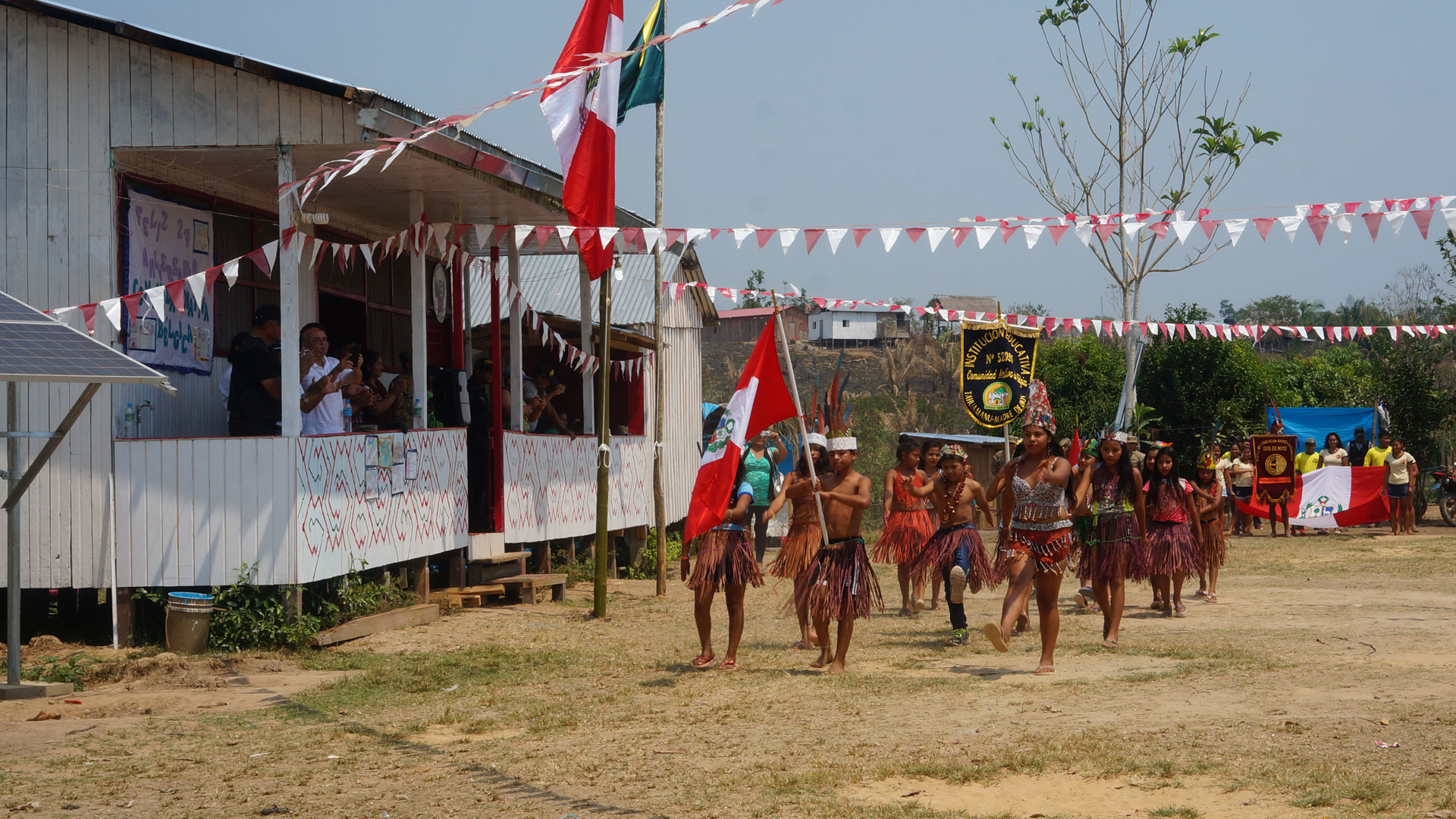 Children in traditional ceremonial dress taking part in a parade