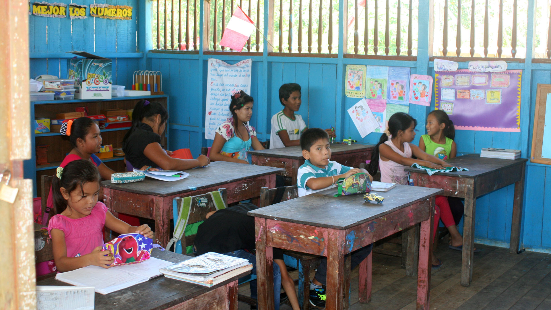 Indigenous Peruvian children sitting at desks in school