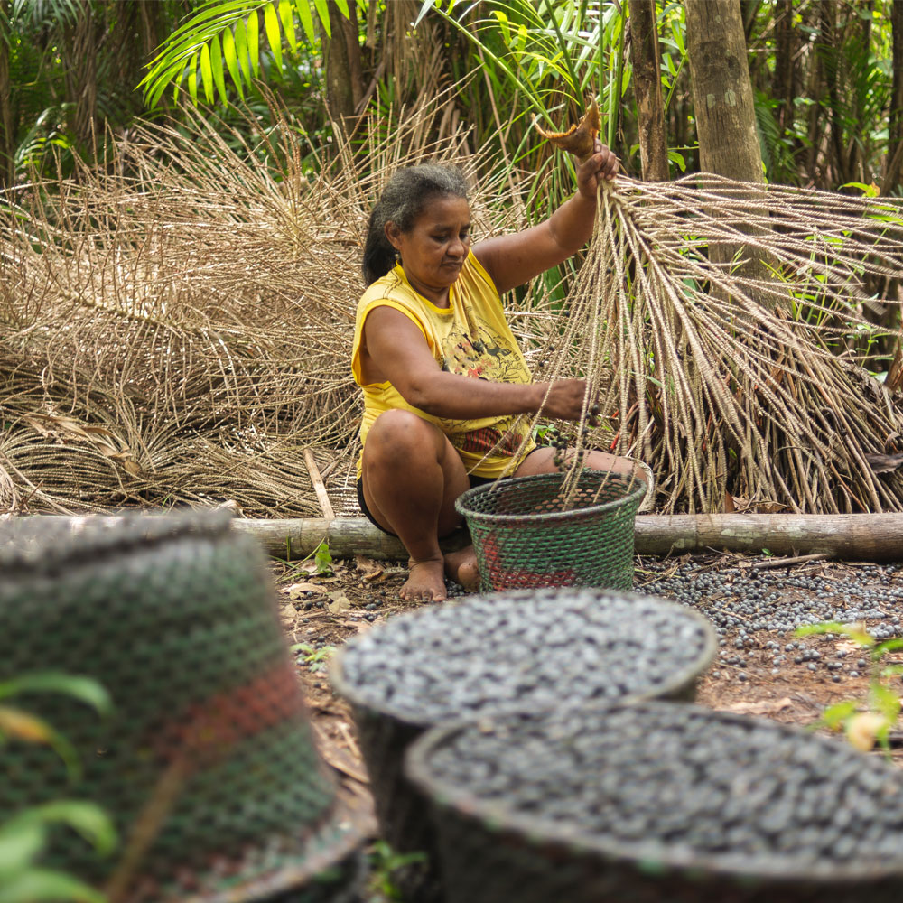 Woman making weaved baskets in the forest