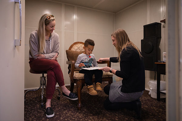 mother and child visiting with an audiologist