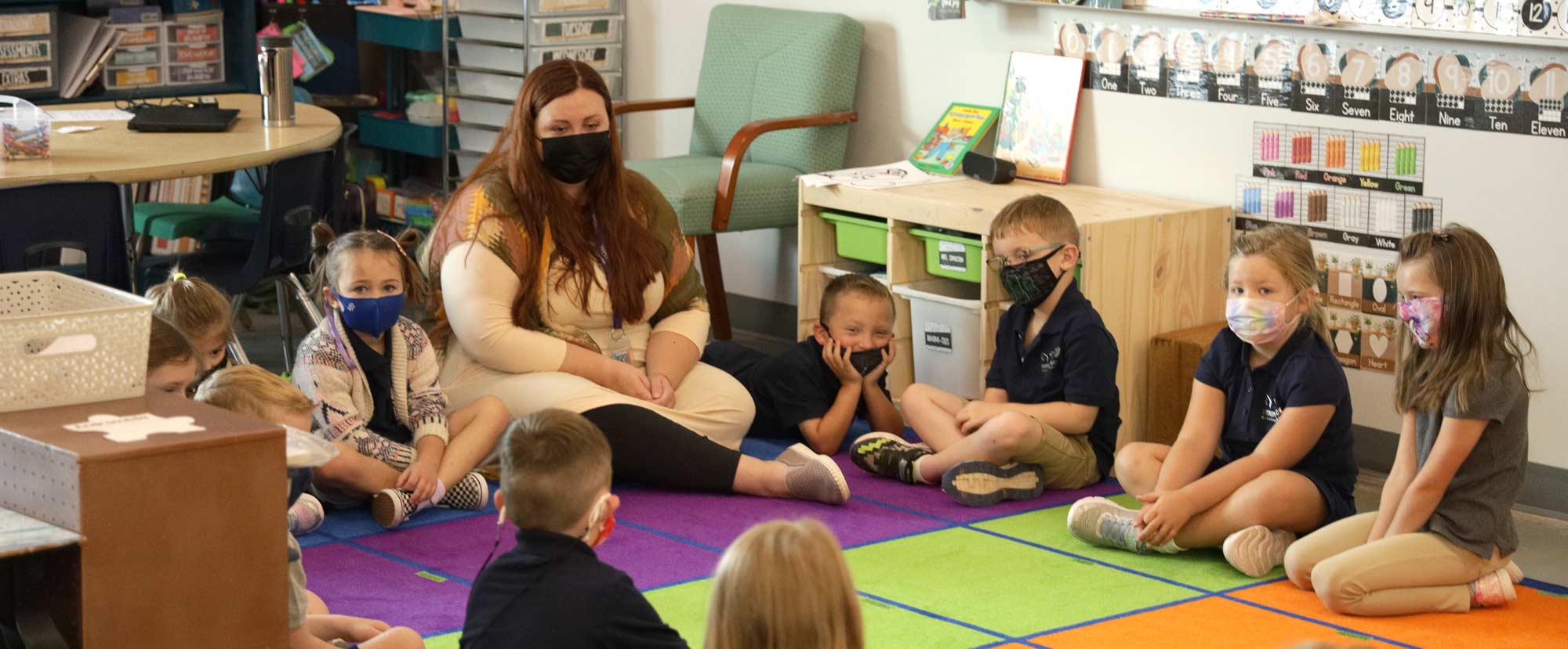 Students masked up in classroom with teacher