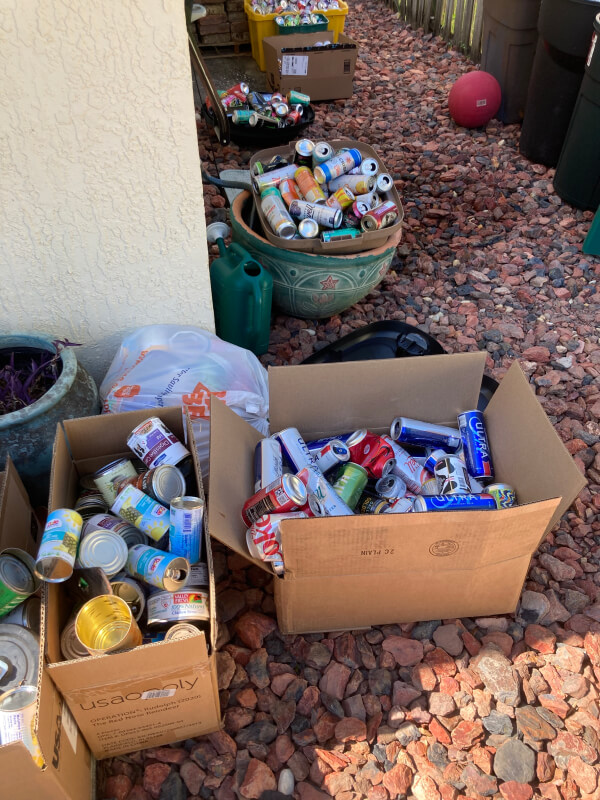 Card boxes and a large pot filled with empty cans