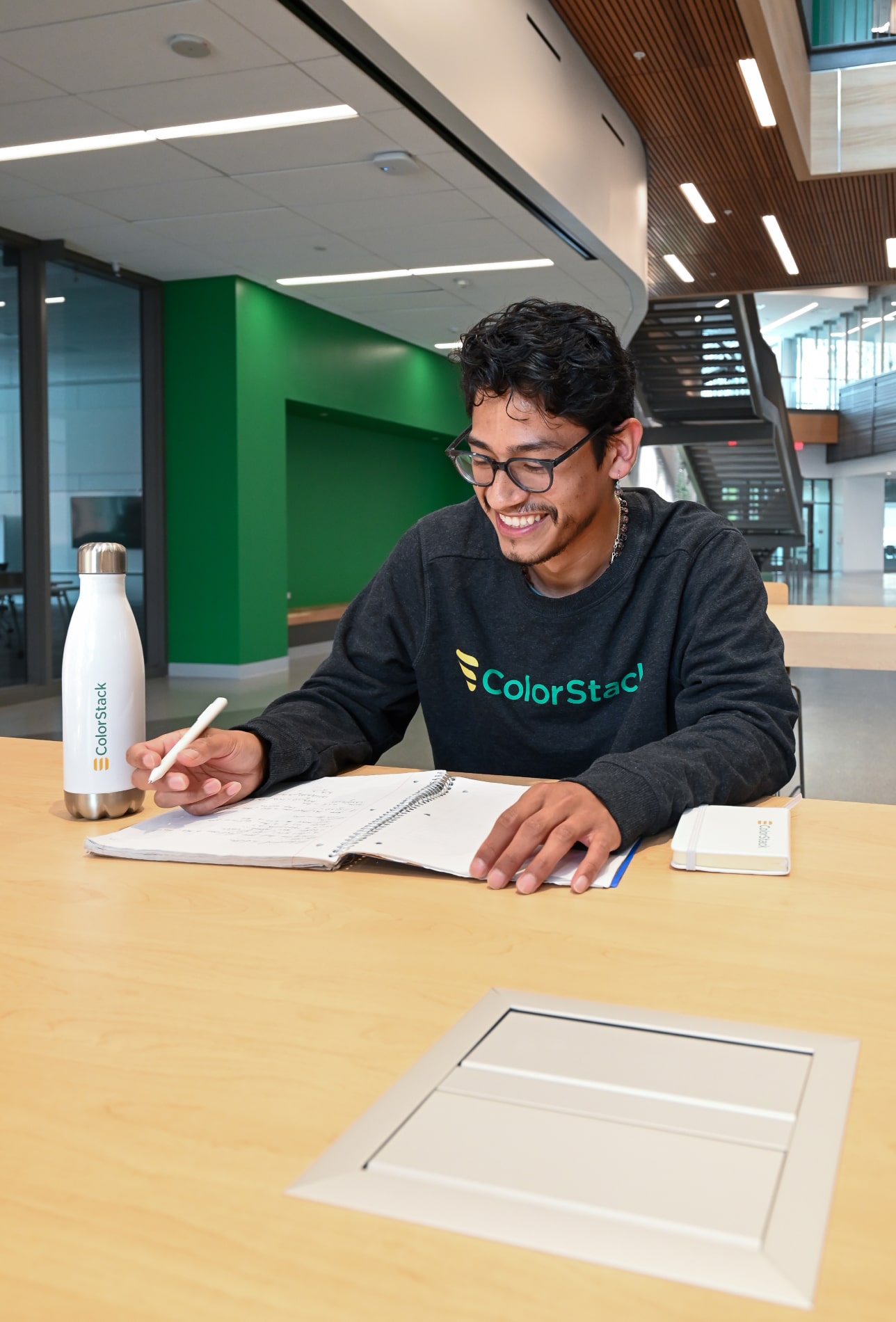 ColorStack student, sitting at a table and studying