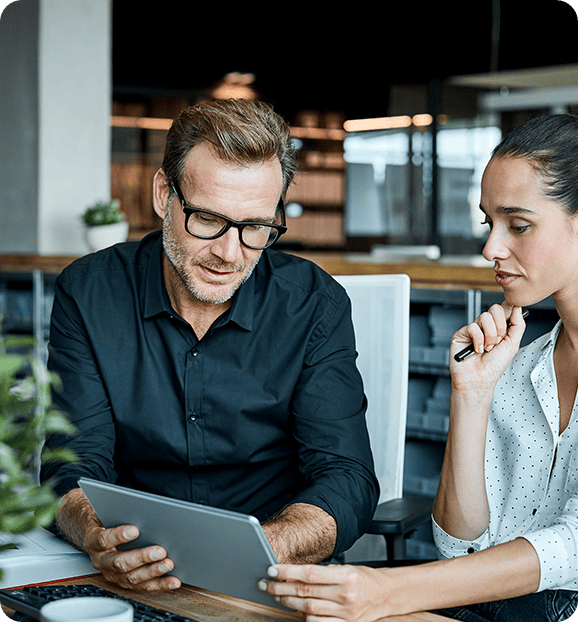 Man and woman looking at a tablet.