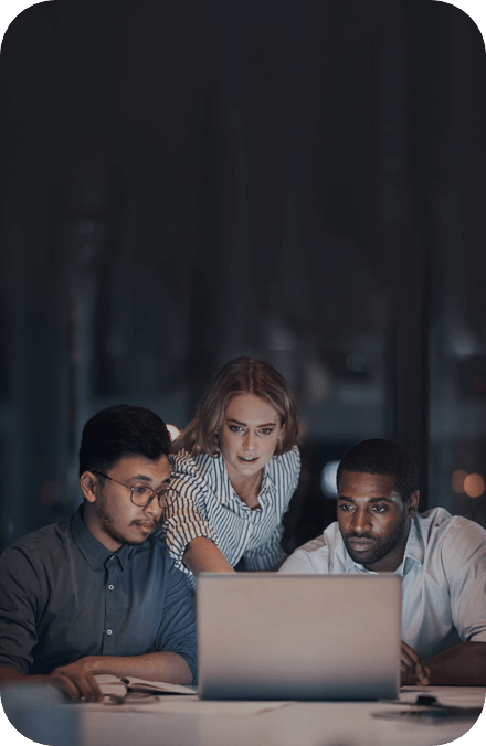Team looking at a laptop.