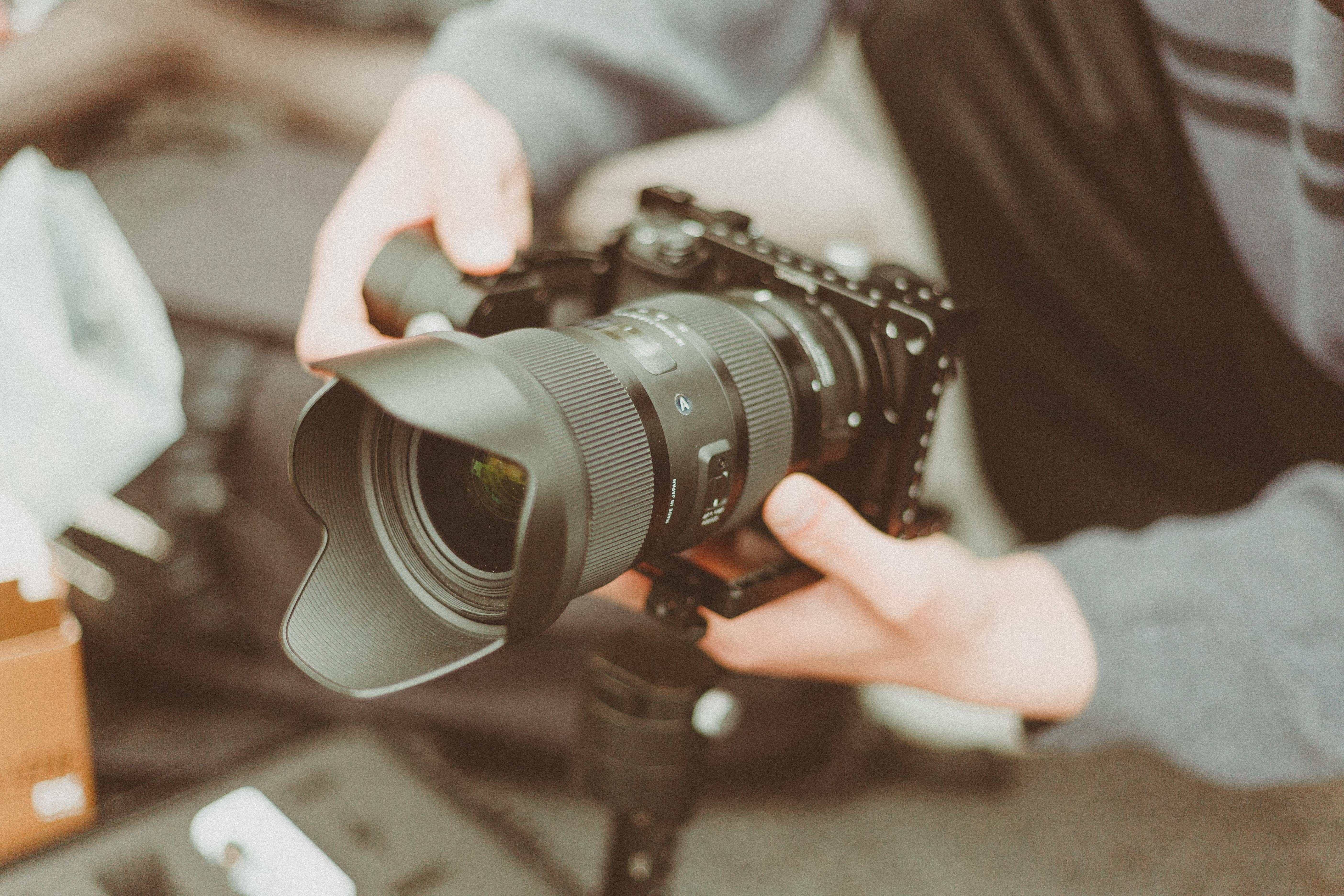 Professional photographer taking photos in a studio with lights and background.