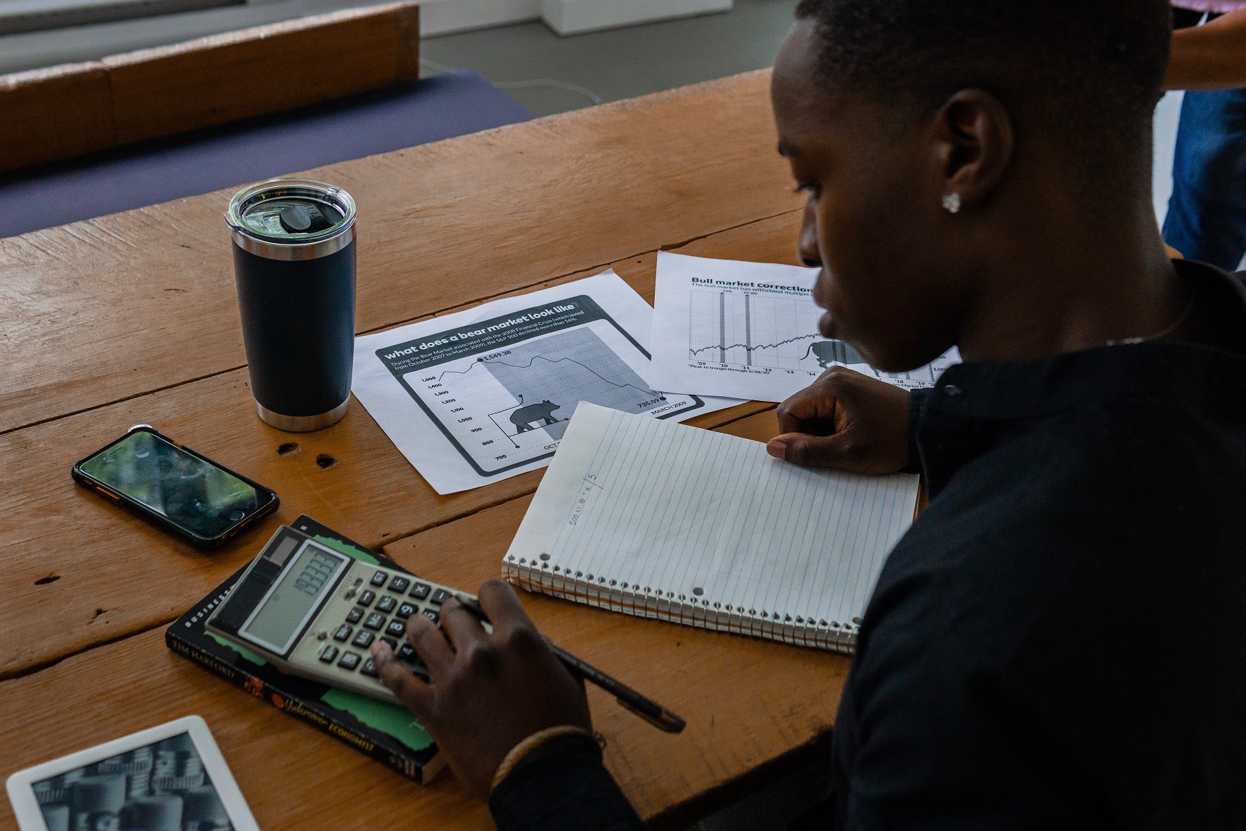 Person using calculator for finances