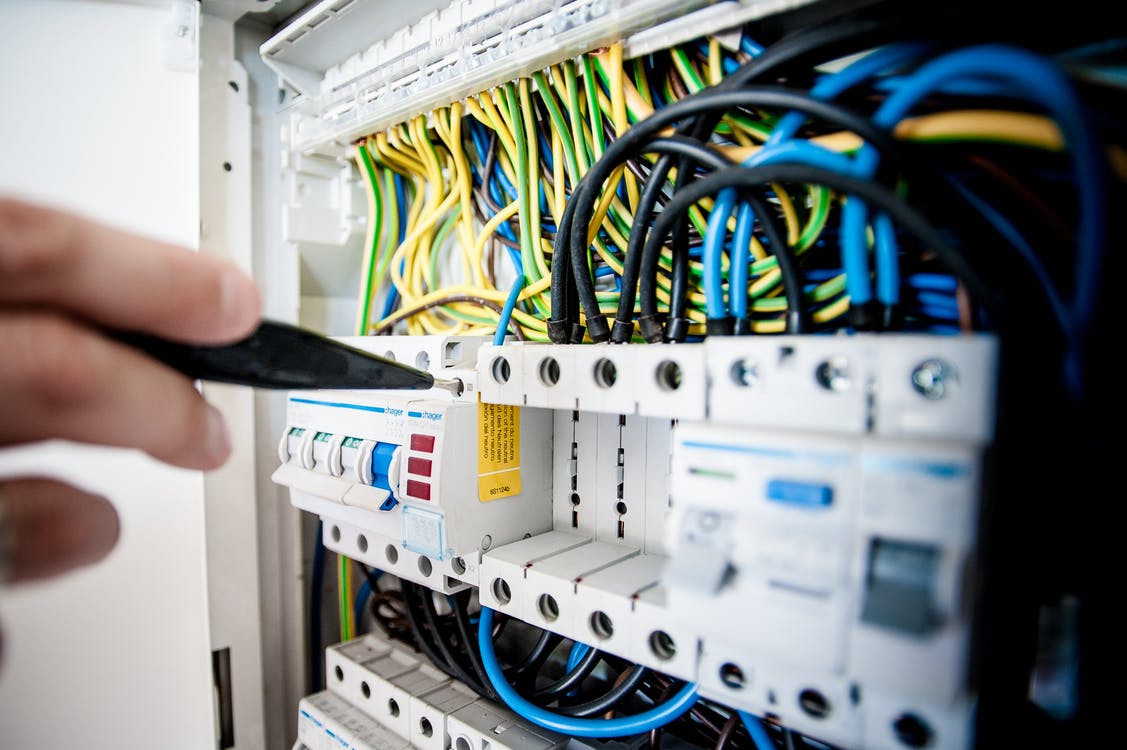 Person fixing an open switchboard