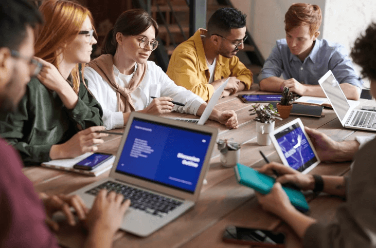 People in a meeting using laptops and tablets