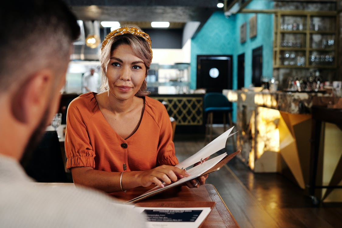 Woman staring at man and holding documents
