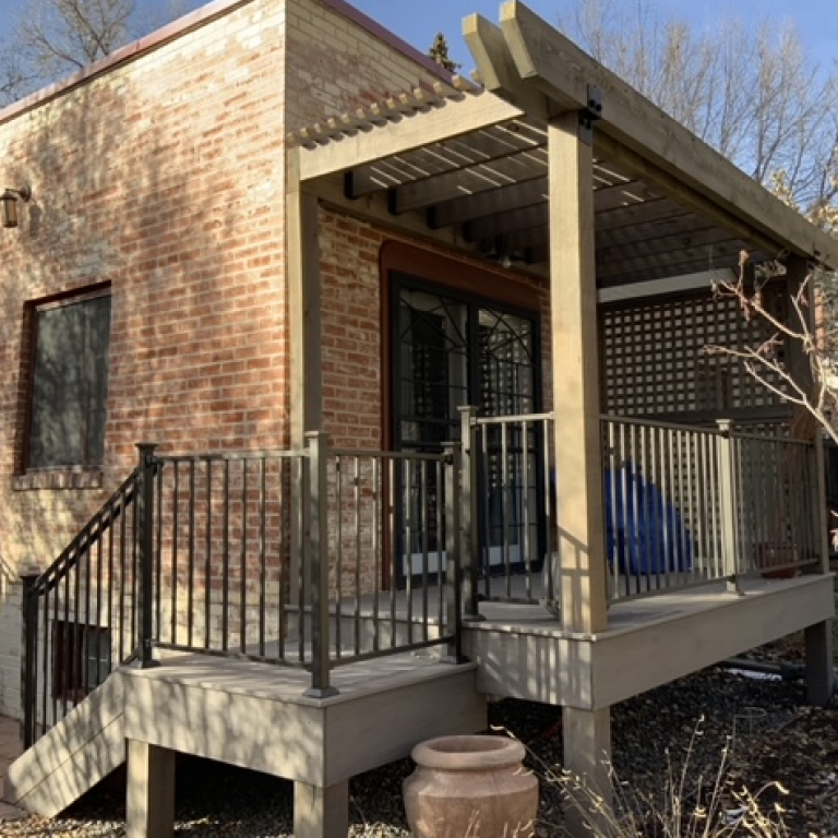 Smaller pergola over a deck with railings