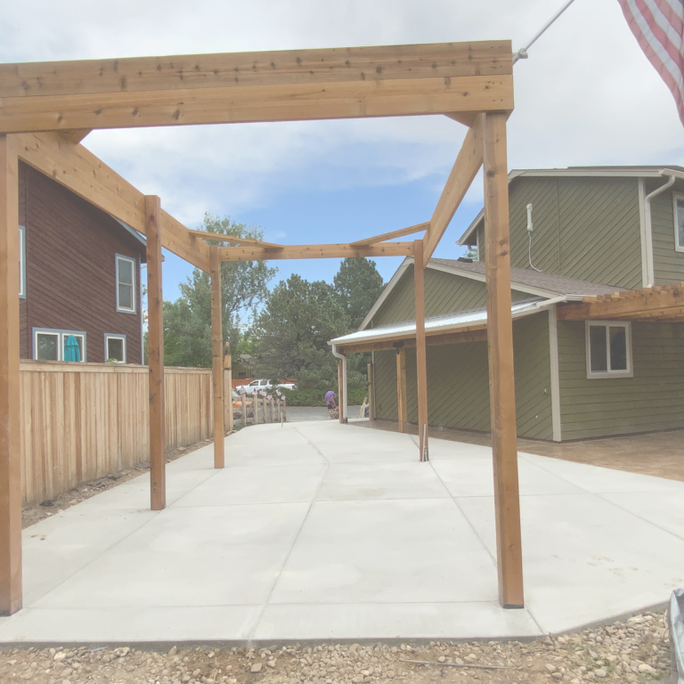 Gray Concrete Patio with Pergola built over it