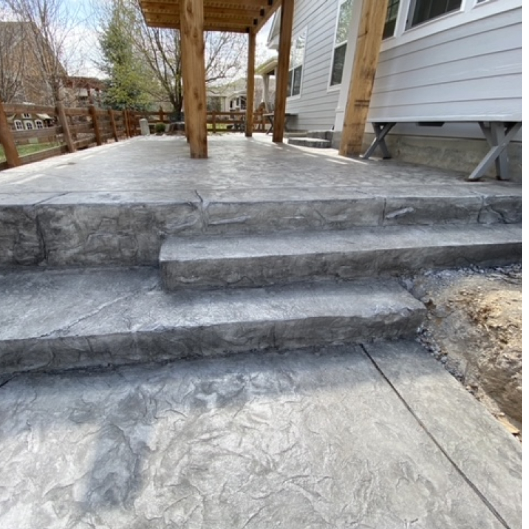 Gray Decorative Stamped Concrete Patio with Chiseled edges and Pergola