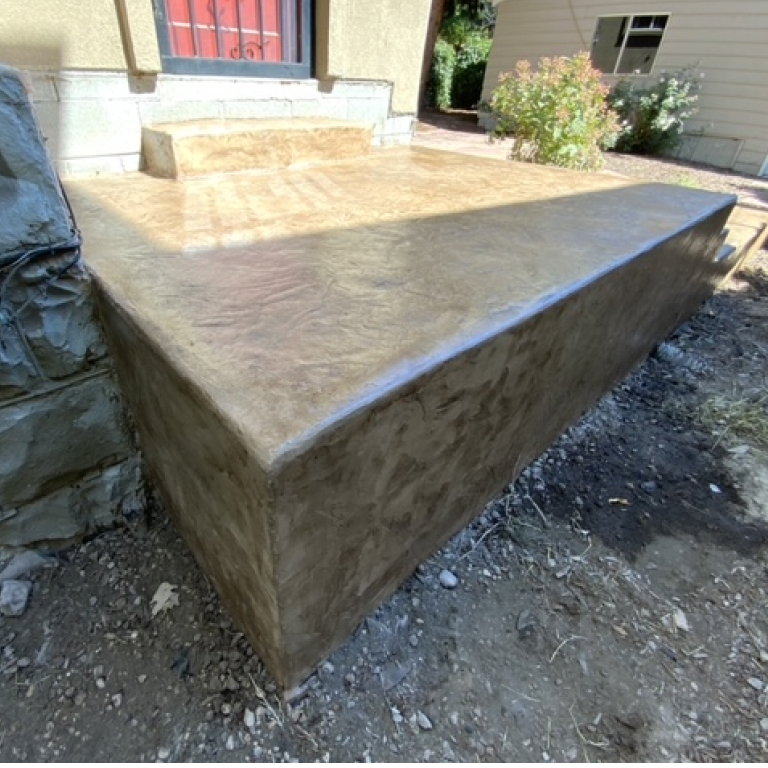 Tan Decorative Stamped Concrete Patio with step