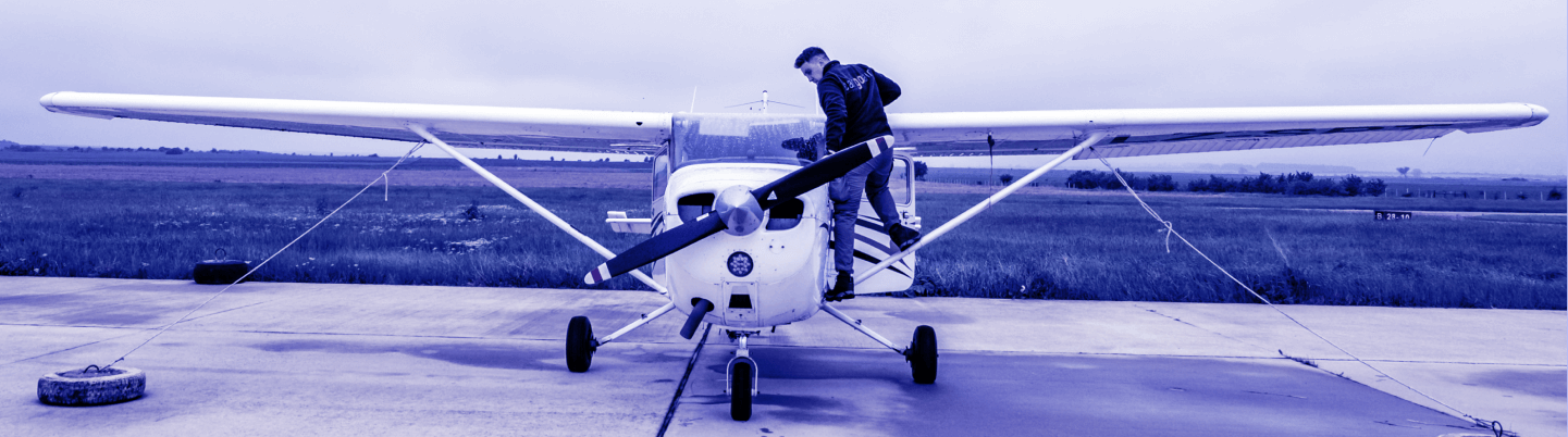 Man on top of an aircraft doing some adjustments