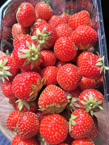 A container filled with fresh, vibrant strawberries.