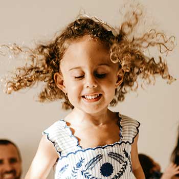 girl with curly hair smiling