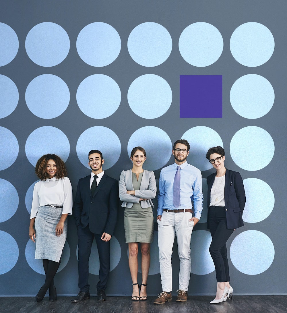 5 young professionals looking into the camera