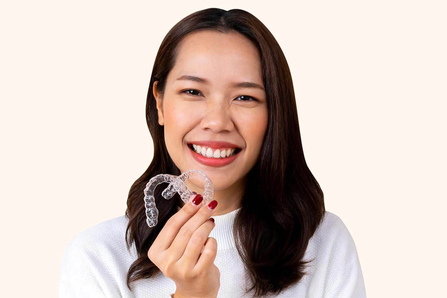 A beautiful lady smiling with Invisalign